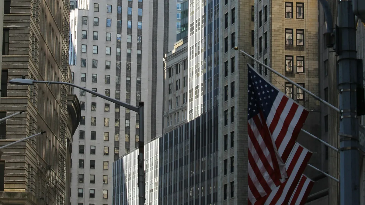 Office buildings and an American flag along Wall Street in Lower Manhattan