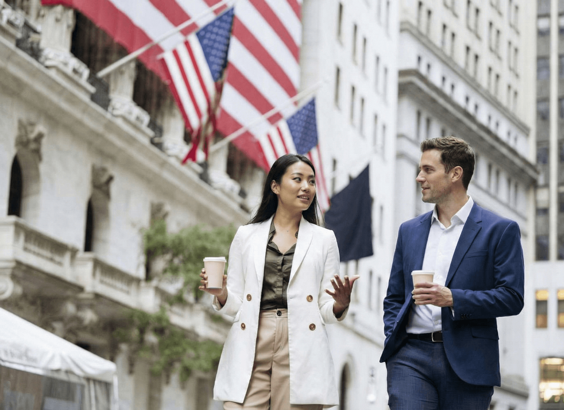 Two young finance professionals walking outside the New York Stock Exchange on Wall Street